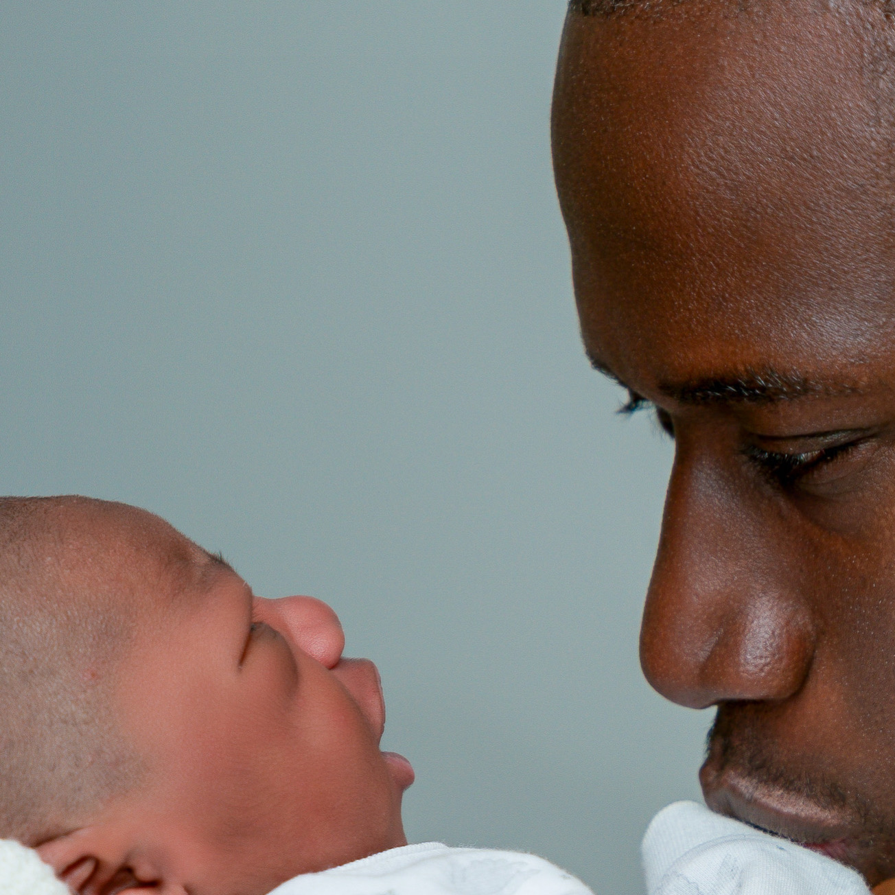 A father sharing a quiet moment with his newborn